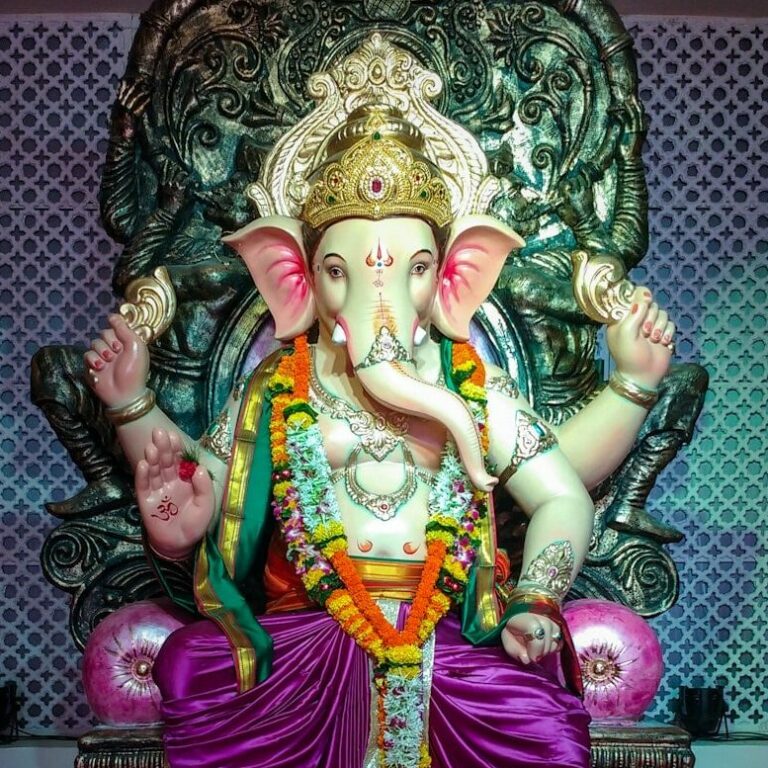 a statue of an elephant sitting on top of a chair